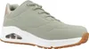 A side view of a single green sneaker against a white background. Voir les images du produit