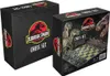 Two boxes of a Jurassic Park themed chess set are shown. The box on the right is open, revealing the chess board and pieces. Podgląd zdjęcia produktu