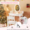 A child's white vanity table and stool are set up in a festive, possibly Christmas-themed, room. The vanity has a lighted mirror and several cosmetic items on top. A Christmas tree with ornaments and lights is visible to the left, and decorative bells are  Voir les images du produit