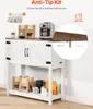 A white farmhouse-style cabinet with a wooden top, used to display coffee-related items. An inset shows an anti-tip kit installation detail. Produktbild-Vorschau