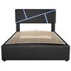 A black upholstered bed frame with a slatted wooden base and a headboard with geometric blue LED lighting, shown from the front. Produktbild-Vorschau