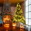 A decorated Christmas tree stands in a cozy living room with a fireplace and gifts. Náhled obrázku produktu