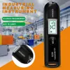 An industrial measuring instrument, likely a thermometer, shown in a factory setting. Produktbild-Vorschau