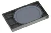 A close-up, angled shot of a gray plastic part with an oval gray insert. Produktbild-Vorschau