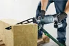 A person is using a reciprocating saw to cut a large block of insulation material. Voir les images du produit