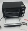 A black Zilan mini oven with its door open, showing the interior rack. A user manual is placed next to it. Produktbild-Vorschau