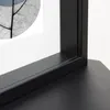 A close-up view of a black picture frame with a white mat and a partially visible artwork of a leaf with blue accents. Produktbild-Vorschau