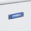 A close-up of a white surface with a blue and clear plastic label attached. Náhled obrázku produktu