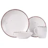 A set of white ceramic dishes with a speckled design and a brown rim, arranged on a white background. Náhled obrázku produktu