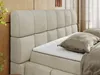 Close-up of a bed with a tufted headboard. Produktbild-Vorschau