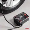 A car tire and a portable air compressor are shown on a concrete floor. Náhľad obrázku produktu