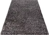 A shaggy rug with a mottled gray and brown design is shown from a diagonal angle on a white background. Náhled obrázku produktu