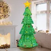 A decorated Christmas tree with lights and ornaments in a room with a fireplace and a window. Náhled obrázku produktu
