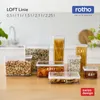 A collection of Rotho Loft Line food storage containers of various sizes are displayed on a wooden table. Produktbild-Vorschau