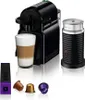 A Nespresso coffee machine with a glass of coffee, coffee capsules, and a milk frother. Produktbild-Vorschau