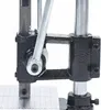 A close-up view of a manual stamping machine, focusing on the lever mechanism and the base with a grid pattern. Voir les images du produit