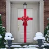 A decorated front door in winter with snow on the ground and on urns flanking the steps. Náhled obrázku produktu