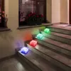 Illuminated cube-shaped solar lights in various colors are placed on outdoor steps at night. Produktbild-Vorschau
