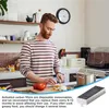 A man is preparing food in a kitchen, with a product advertisement overlay at the bottom. Produktbild-Vorschau