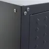 A close-up view of the corner of a dark gray metal cabinet, showing two screws on the right side and one screw on the left side. Voir les images du produit