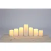 A set of seven LED candles of varying heights arranged on a wooden surface against a light gray background. Produktbild-Vorschau