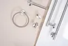A collection of brushed steel bathroom accessories laid out on a light beige and white surface. Podgląd zdjęcia produktu