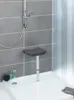 A shower seat mounted on a tiled wall in a shower stall. Produktbild-Vorschau