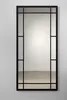 A tall, rectangular mirror with a black frame, mounted on a light gray wall. Produktbild-Vorschau
