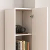 A close-up view of a white bookshelf with an open door, revealing a camera and books. Podgląd zdjęcia produktu
