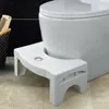 A white toilet stool is placed in front of a white toilet. Anteprima dell’immagine prodotto