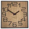 A square wooden wall clock with black numbers and hands. Produktbild-Vorschau