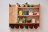 A wooden wall shelf with various kitchen items and mugs hanging from hooks. Náhľad obrázku produktu
