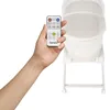 A hand holding a remote control for a baby bassinet. Anteprima dell’immagine prodotto