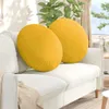 Two yellow round cushions on a white sofa in a living room setting. Podgląd zdjęcia produktu