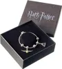 A Harry Potter themed bracelet with charms is displayed in its open gift box. Podgląd zdjęcia produktu