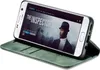 A smartphone in a green flip case is displayed on a surface, showing a movie poster on its screen. Produktbild-Vorschau