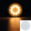 A close-up shot of a circular LED light bulb emitting warm yellow light, with a smaller inset image of the same bulb on a white background. Produktbild-Vorschau