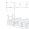A white metal bunk bed with storage drawers underneath, shown from a side angle. Anteprima dell’immagine prodotto