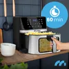 A hand is shown pulling out the basket of a black and silver air fryer filled with french fries. The air fryer is on a wooden countertop with two white bowls next to it. A blue circle with a stopwatch icon and the text '60 min' is in the upper right corner Produktbild-Vorschau