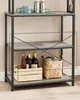 A three-tiered shelving unit with items on the shelves, including bottles, a basket, and mugs. Náhled obrázku produktu
