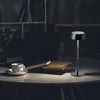 A desk scene at night with a laptop, books, and a cup of coffee, illuminated by a table lamp. Náhľad obrázku produktu