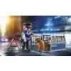 A police officer and two dogs are on a street at night, with a police barrier and a warning sign. Anteprima dell’immagine prodotto