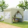 A khaki colored gazebo set up on a green lawn with a white fence in the background. Náhled obrázku produktu