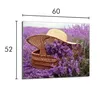 A straw hat and basket filled with lavender flowers in a lavender field. Náhled obrázku produktu