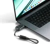 A small, silver external SSD enclosure is plugged into the side of a laptop. Anteprima dell’immagine prodotto