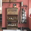 A hallway or entryway with a shoe cabinet, coats hanging on hooks, and boots on the floor. Produktbild-Vorschau