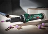 A rotary tool with several grinding accessories is laid out on a wooden surface next to a metal pipe. Produktbild-Vorschau