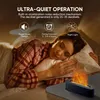 A woman sleeping in bed next to a small flame-shaped aroma diffuser. Produktbild-Vorschau