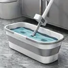 A mop is being used in a bucket of water, likely for cleaning a floor. Podgląd zdjęcia produktu