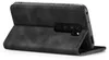 A black flip cover case for a smartphone is shown from a side angle, with the phone inserted and the cover partially open. Produktbild-Vorschau